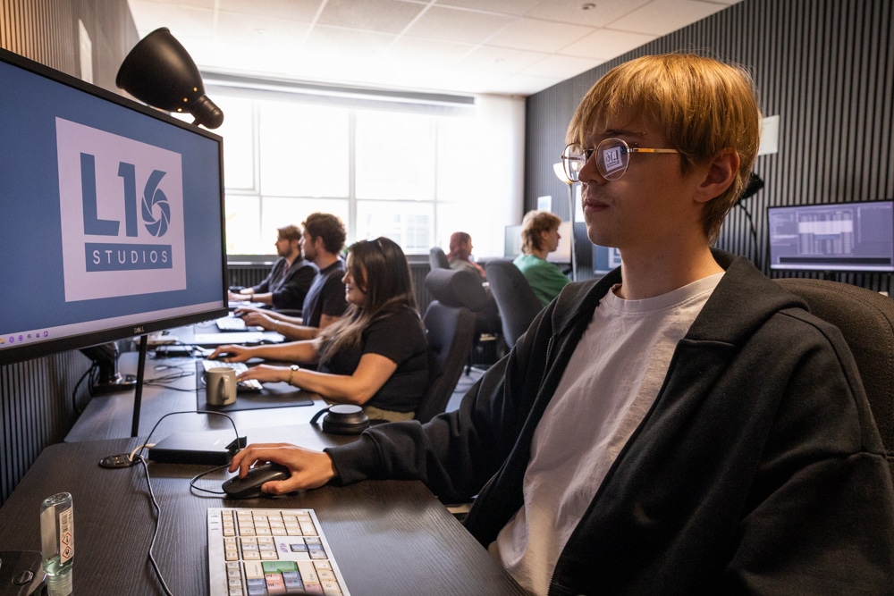 Someone working in an edit suite with L16 STudios on the computer screen
